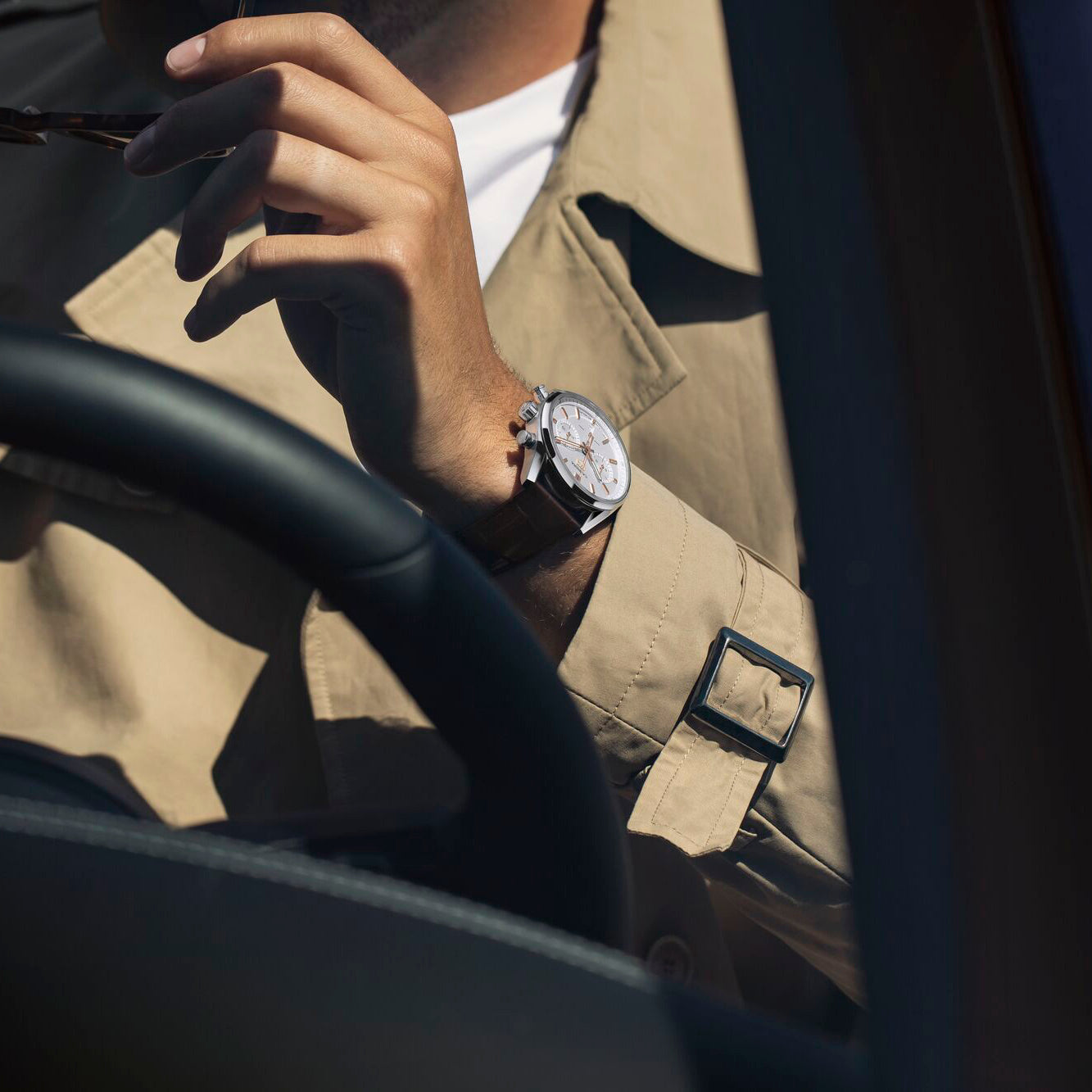 Man Wearing TAG Heuer Carrera Elegant Men's Calibre Heuer 02 Automatic Chronograph Silver Dial Watch with Leather Strap